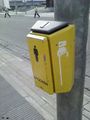 This photo shows a button of a set of traffic signals with an arrow to indicate the direction of crossing for blind persons.