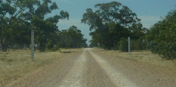 La même route (non inondée), avec une échelle plantée pour mesurer (jusqu'à 2 mètres) et indiquer la hauteur d'eau pouvant être atteinte (2).