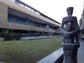 View of the Snape teaching block with a sculpture.