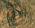 7/8 Communication tower (man_made=tower and tower:type=communication), with an antenna and a small building, on top of a plain (Maxar satellite imagery).